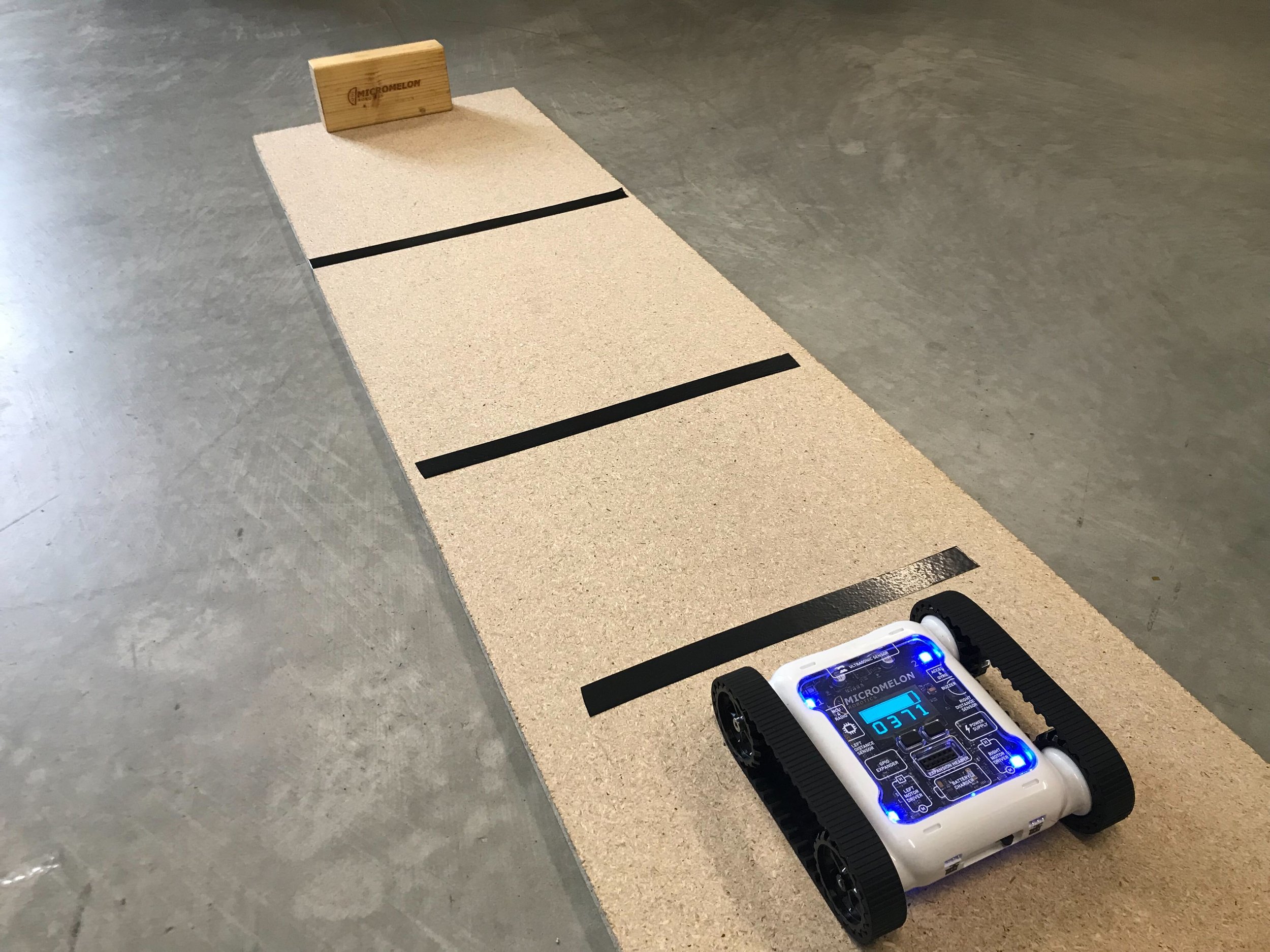 Rover on a platform with tape strips, ready to log brightness data