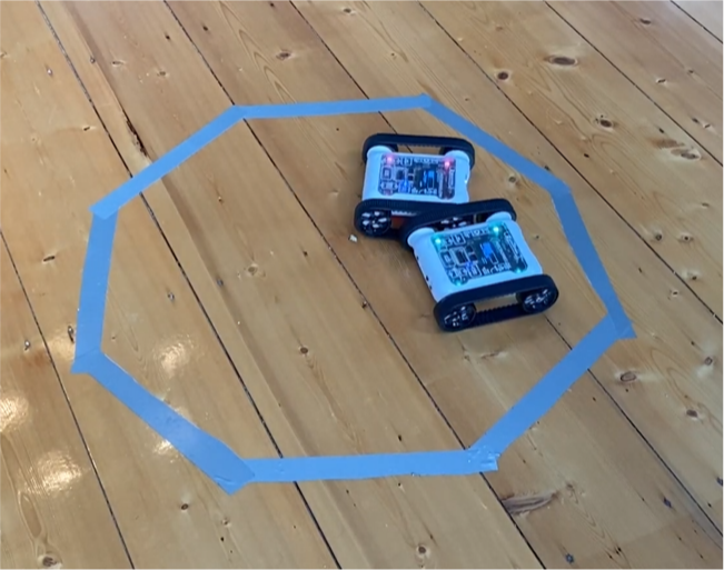 Octagon-shaped sumo arena made with masking tape, a very cheap setup
